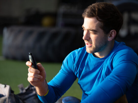 Man Holding Biosense Device Sitting At The Gym