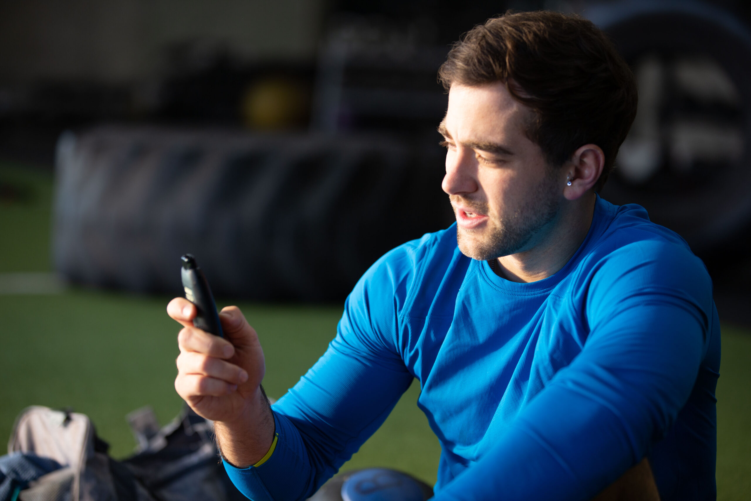 Man Holding Biosense Device Sitting At The Gym